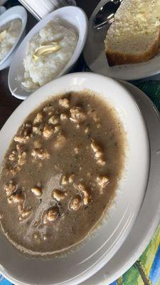 Stewed conch, grits, and Johnny cake