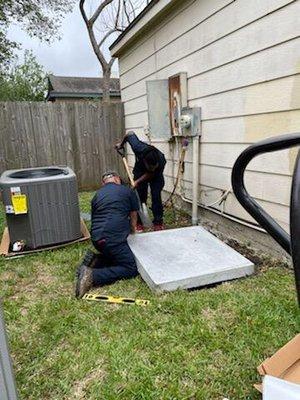 Swift air tech making sure the concrete set is leveled for that perfect install .