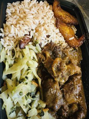 Oxtails Rice & Peas along with cabbage