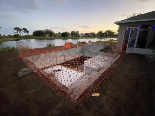 Unfinished pool with dirty water, frogs  in pool