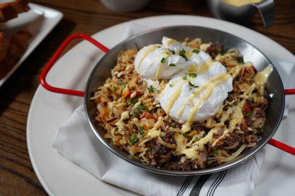 Short Rib Hash: braised short ribs, crispy potatoes, red & yellow peppers, poached eggs, hollandaise