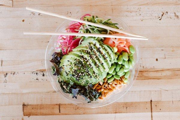 Avocado Queen:avocado, baby kale, roasted almonds,rice puffs,watermelon radish, wasabi peas, cucumber, edamame, pickled ginger, sesame sauce