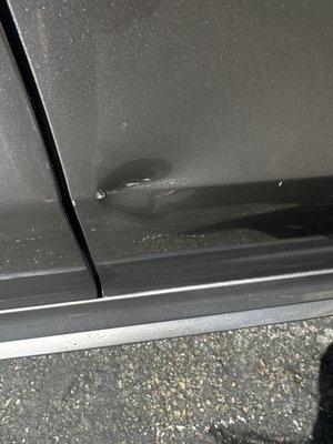 A big dent, and plus scratched on the passenger side door on a brand new Mercedes