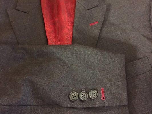 Contrast button hole stitching with fancy red paisley lining