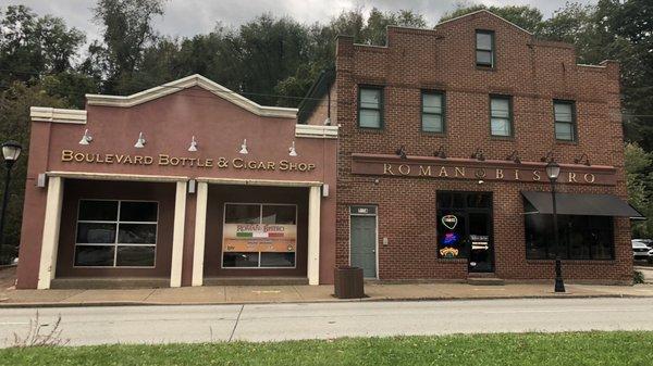 Storefront from the street - off street parking lot and entrance on right side of buildings