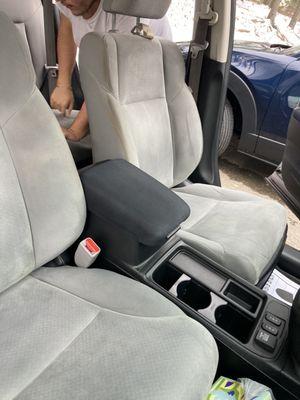 Before- Diet Coke and water stains on passenger seat, dirty driver's seat.