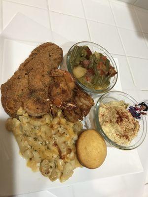 Fried fish, fried prawns, macaroni & cheese, potato salad, string beans, cornbread muffin