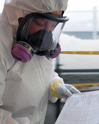 BioteamAZ technician reviewing a list of items to set aside for a client.