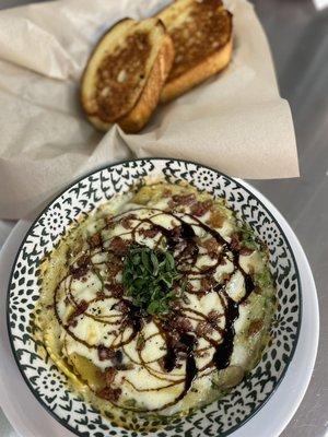 Wild mushroom ravioli, and a house made white wine, cream sauce with arugula, sautéed onions, sun-dried tomatoes, and bacon