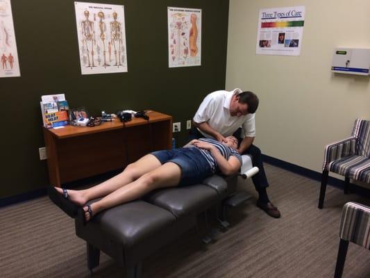 Dr. John Schmidt adjusting a patient in for her wellness tune up!