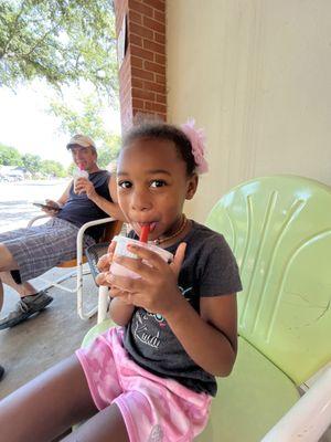 Little Izzy enjoying her strawberry banana smoothie.