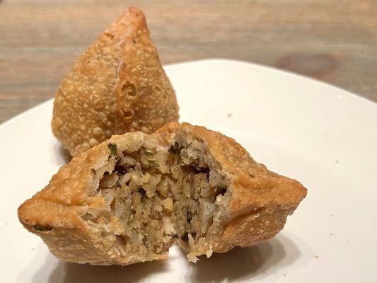 Samosa. Densely crisp outer shell, with potatoes and vegetables inside. It's a heavy appetizer, so share it!