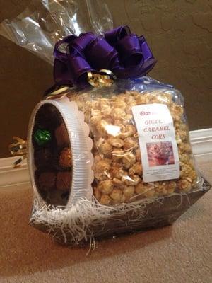 This gift basket has three different types of popcorn and an assorted box of chocolates.