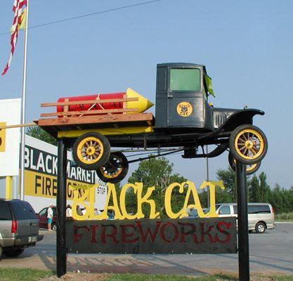 Black Cat Truck in front of store.