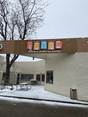 Outside sign on a snowy day.