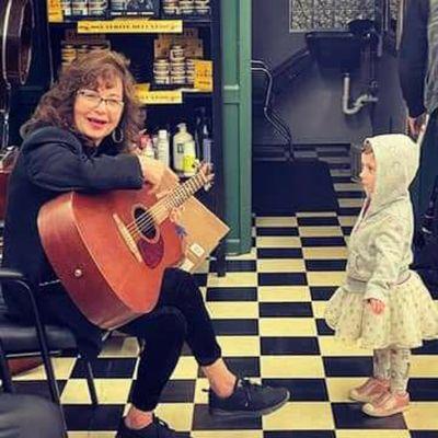 Brenda serenading our cute client Estelle.