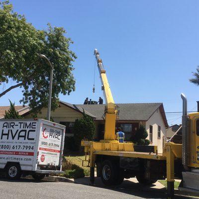 Using a crane for HVAC installation on our home.