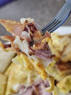 A fork with a piece of Paul's Omelet in Close-up.