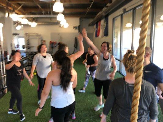 Sweaty high-fives after a challenging but fun boot camp workout.