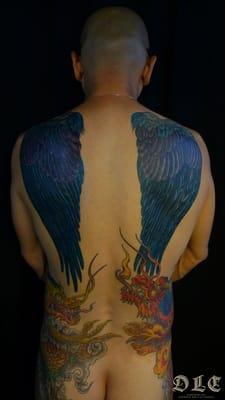 Wings on the back which cover up some poorly done wings that he had already. All these were drawn specifically for the wearer.