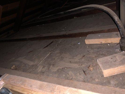 Unfinished attic floor at the new entry point, with no plywood floor installed.