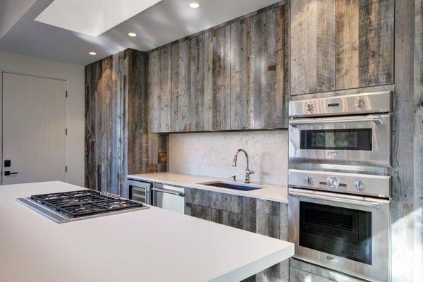 This modern kitchen has a rustic flair.  Our weathered gray barn wood was used to make cabinets in this amazing space.