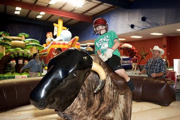 Games shown: Wild West Mechanical Bull, Wet/Dry Obstacle Course, Pirate Ship Adventure, and Kiddy Grand Prix.