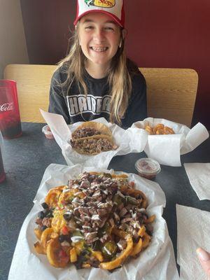 Tri-tip loaded Nachos, Tri-tip Taco, Chicken Taco, and Curly Fries.