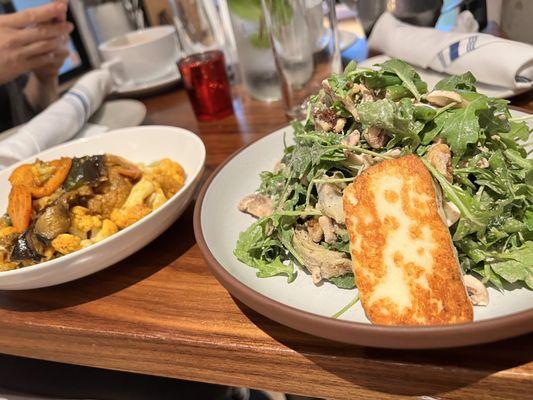 Spiced Fall Vegetables - roasted vegetables & plated over green tahini sauce and Grilled Halloumi Cheese & Artichoke Heart Salad