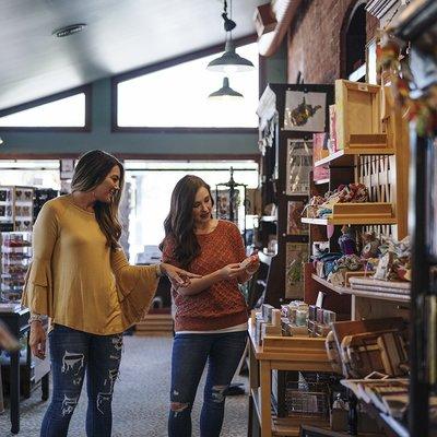 Two regular customers explore the new items in the shop.