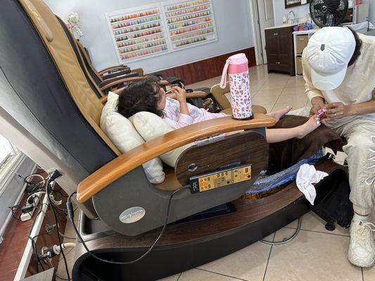 Tiny human pedicure, a lollipop, and TV- she was in heaven!