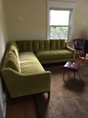 Down-filled velvet sectional in wasabi green with blind tufting and flat stitching.