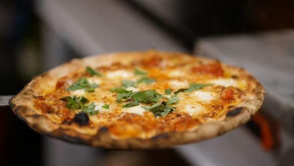 San Gennaro - mixed sausage, wood fired red peppers & onions, mozzarella, basil, EVOO - out of this world with Mike's Hot Honey!