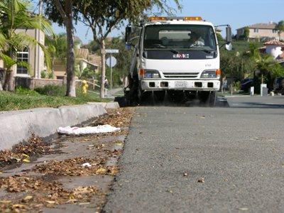 Vacuum truck sweeping up leaves