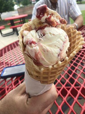 Waffle cone with strawberry cheesecake ice cream