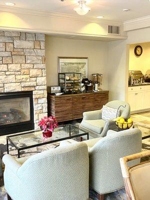 Nice lobby fireplace area for eating the offered breakfast, this shows just a portion of the food area with breads to toast.