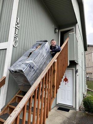 Using hand truck to dolly a dresser down a flight of stairs.