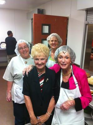 Members of St Anthony on the Desert serving a meal at EVMC.