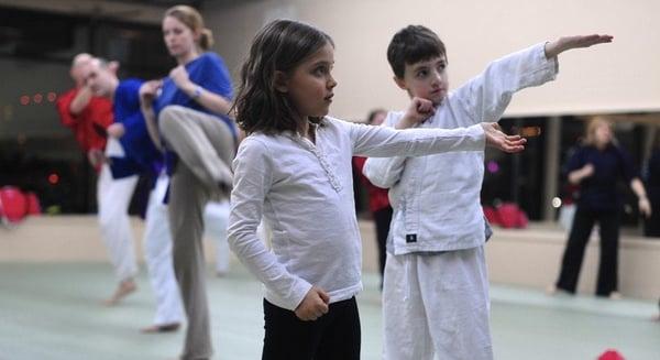 parents and kids working out, exploring and learning new things together in family class at mercer island martial arts.