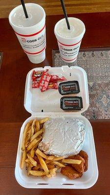 Tray with big double burger, Cajun fries, and chicken nuggets plus a Coke and shake