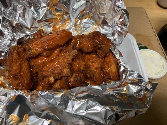 Order of 12 piece bone-in wings, hot buffalo sauce with ranch ($10.99 + tax).