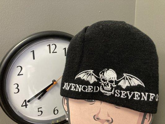 in the seating/waiting area:  a wall clock that runs backwards, a cap from Avenged Sevenfold, etc.