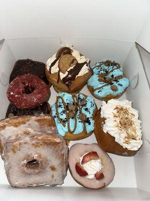 Boston crème, cronut, red velvet, strawberry shortcake, cookie monster, banana cream, coconut cream, and maple bacon