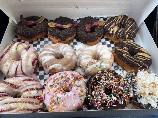 Dirt, choc pb, strawberry cheesecake, cinnamon roll, strawberry sprinkles, choc sprinkles and Samoa donuts