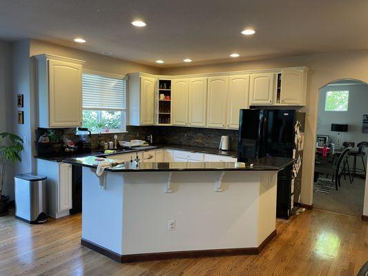 We cleaned, primed and painted these previously stained kitchen cabinets.