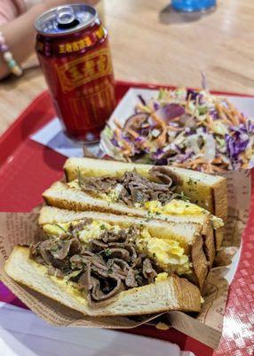 Beef and egg sandwich with truffle, side of cole slaw and drink