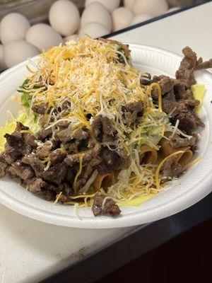 Supreme rolled tacos topped with carne asada, cheese,guacamole, sour cream pico and lettuce