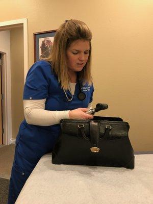 Dr. Tabor-Manaker organizing her medical bag after a home visit.