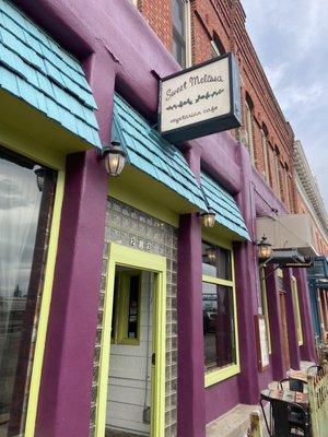 Colorful restaurant entrance. Limited outdoor seating.