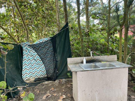 Showers are behind the curtain yet the back is open to campers in the field.